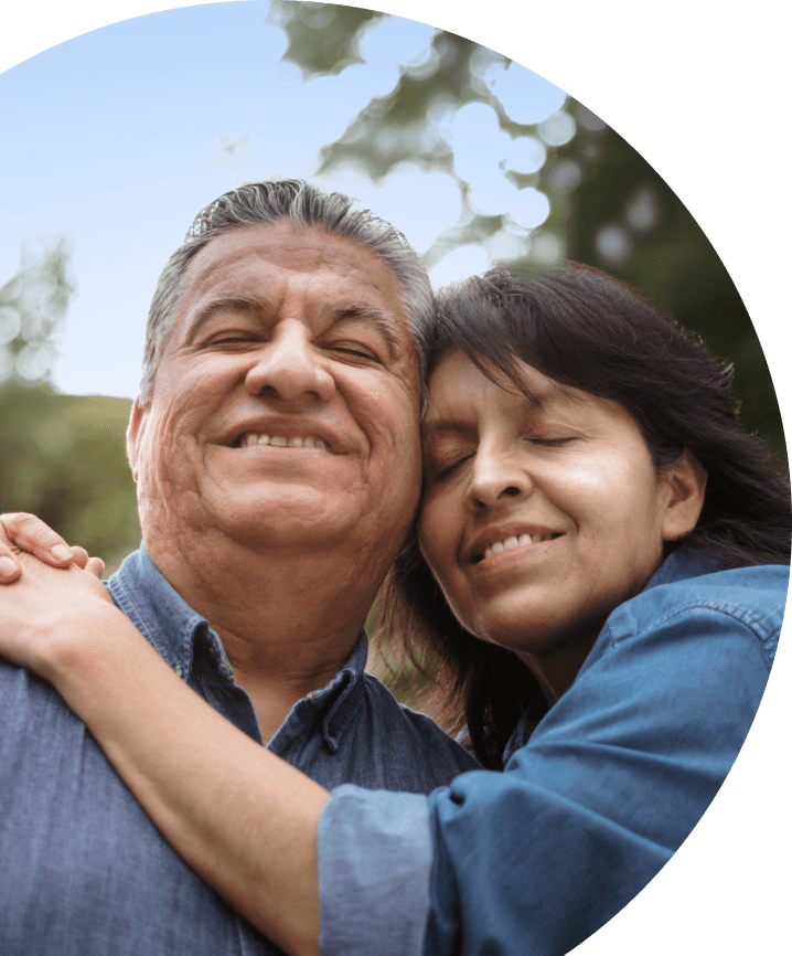 Caregiver and their partner with agitation in Alzheimer's dementia warmly embracing